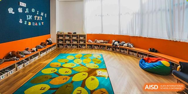 The colorful early years or primary reading room at Harrow Lide High School Nanning with soft flooring and bookshelves.