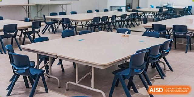 Empty dining area or canteen tables and chairs at Harrow Lide High School Nanning, ready for student meals.