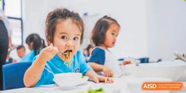 Young Harrow Lide High School Nanning students enjoying a healthy meal together in the school dining area.