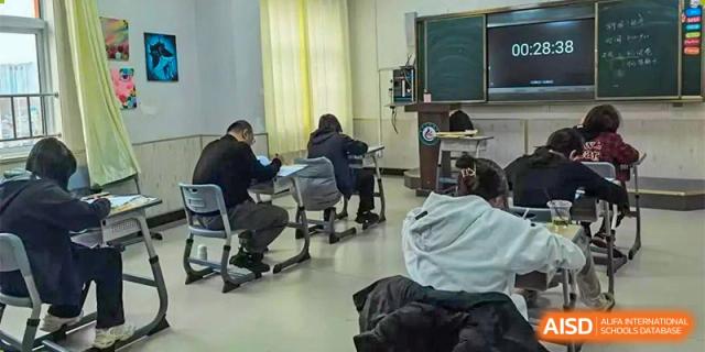 Students are diligently studying or working at desks in a classroom at Guokai International School of Qingdao.