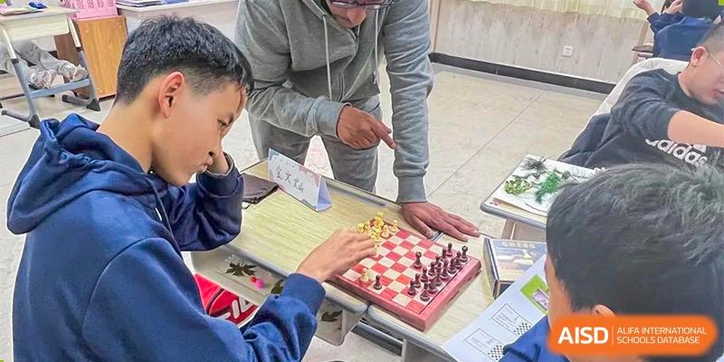 A close-up of a chessboard where students are playing a game during an activity at Guokai International School of Qingdao.