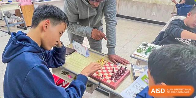 A close-up of a chessboard where students are playing a game during an activity at Guokai International School of Qingdao.