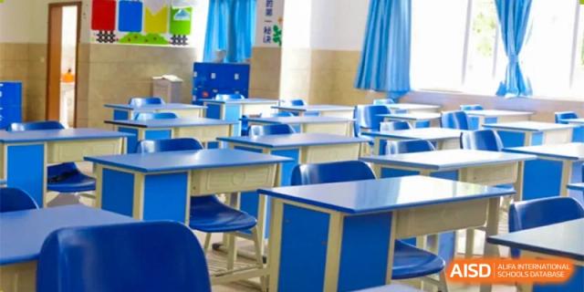 A row of blue desks and chairs in a classroom at Chengdu Meishi International School.