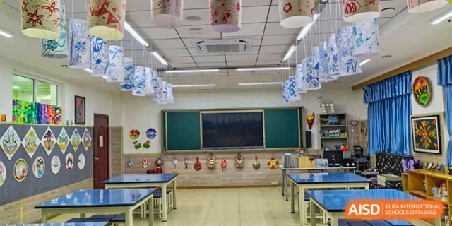 A view of a classroom with desks, chairs, and a blackboard at Chengdu Meishi International School.