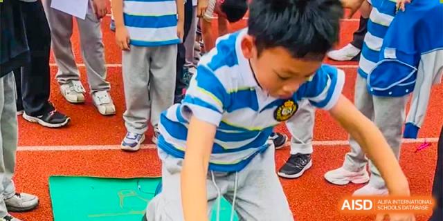 A close-up of a student from Chengdu Meishi International School bending down during a track and field event, focused and ready to compete.