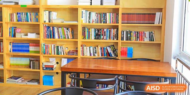 A bookshelf filled with books at Qingdao Cornerstone Bilingual School's library.