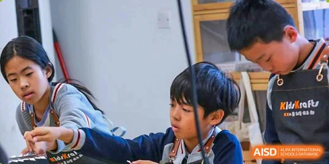 A young Qingdao Cornerstone Bilingual School student playing a violin.