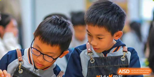 A young Qingdao Cornerstone Bilingual School student focused on a building project.