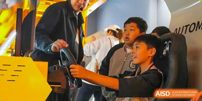 A group of Qingdao Cornerstone Bilingual School students watching a demonstration or a performance.