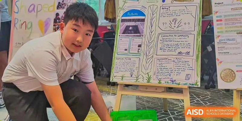 A close-up shot of a student from Tsinglan School painting a picture on a canvas during an art class or event.