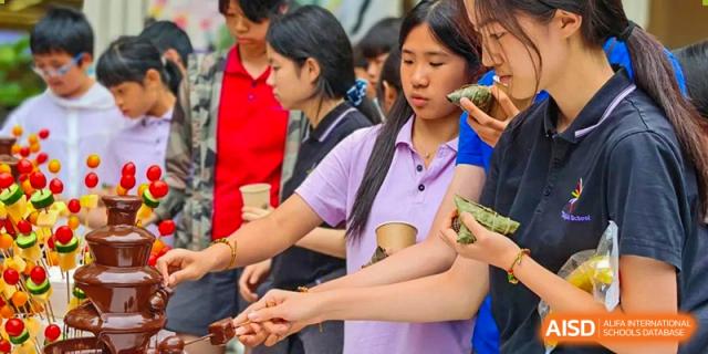 Students from Tsinglan School standing in a line in the school cafeteria.