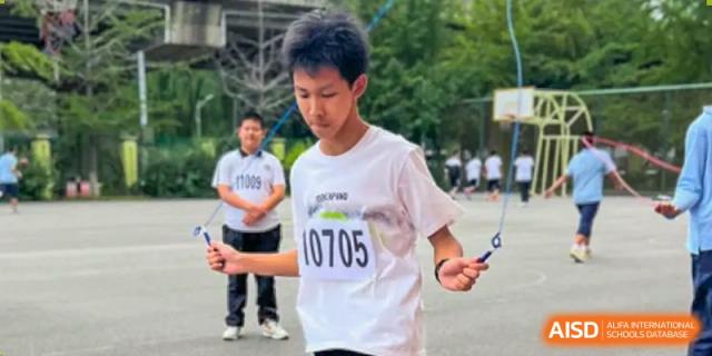 A student from Northeast Yucai Foreign Language School with a race bib jumps rope during a competition.