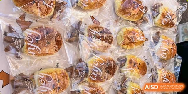 A close-up shot of baked goods wrapped in plastic at an event for Northeast Yucai Foreign Language School.
