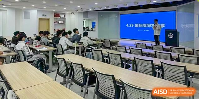 An image of a spacious, modern classroom with many desks and chairs at Shanghai Foreign Language School Affiliated to SISU, ready for a lesson.