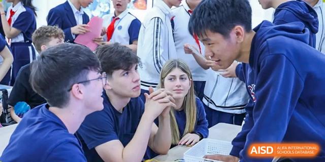 Students from Shanghai Foreign Language School Affiliated to SISU intently listening to a lecture or discussion in a classroom setting.