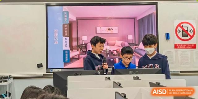 Students from Shanghai Foreign Language School Affiliated to SISU working on a technology project in a room with a modern, pink-lit interior design setting.