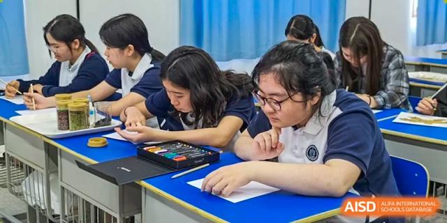 Students from Shanghai Foreign Language School Affiliated to SISU working together on a hands-on art or creative project in a classroom setting.
