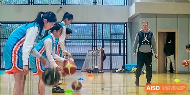 A student is dribbling a basketball during a physical education class at Shanghai Shangde Experimental School.