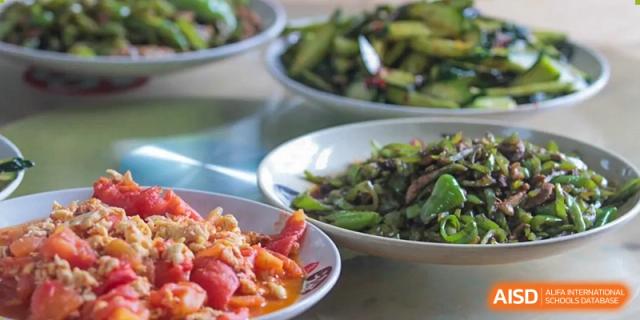 Bowls of fresh, prepared vegetables are shown at Shanghai Shangde Experimental School.
