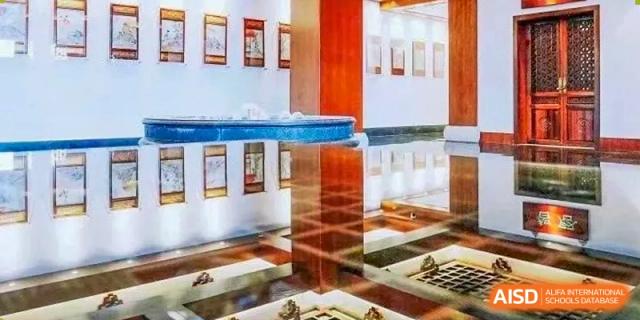 The interior of a modern building with a polished, reflective floor is shown at Shanghai Shangde Experimental School.