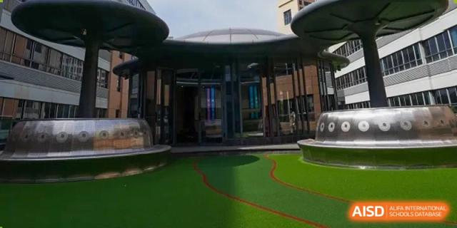 This is a view of a modern building with a covered walkway at Shanghai Shangde Experimental School.
