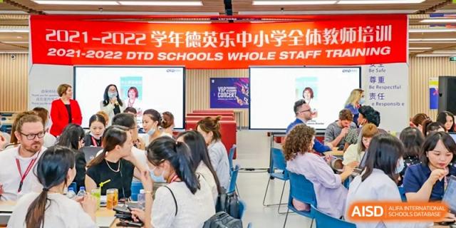 Teachers and staff attending a professional development session or school meeting at Vanke School Pudong.