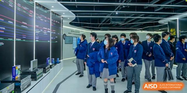 Students in uniform walking together down a hallway, showing student life at Vanke School Pudong.
