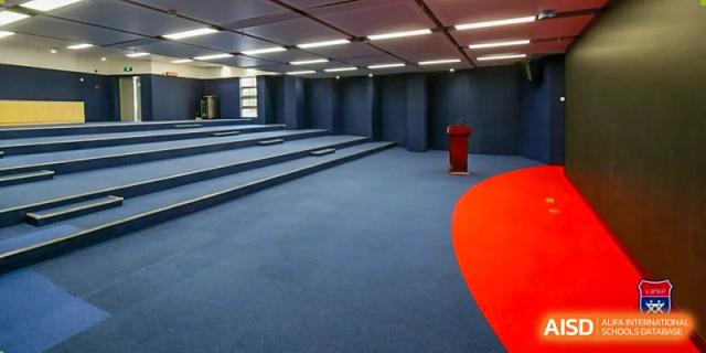 A tiered seating area or small lecture room at Vanke School Pudong with a minimalist design, ready for lessons or presentations.