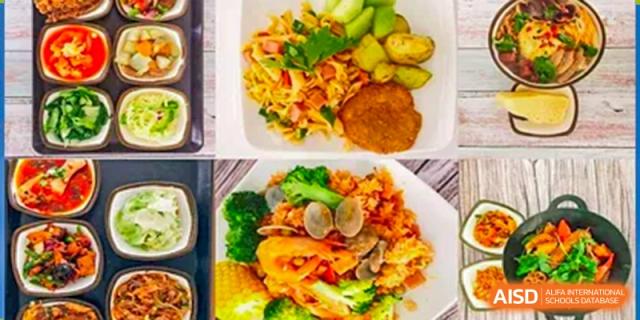 A close-up view of two healthy and balanced student meals served at Vanke School Pudong, featuring vegetables, protein, and grains.