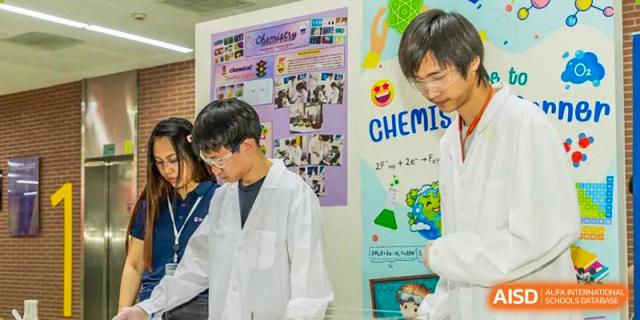 Students from Suzhou North America High School are working on a chemistry project in a lab.