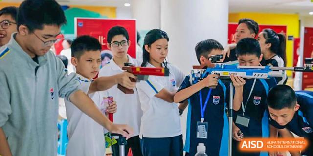 A student from Suzhou North America High School is aiming with a laser gun during a sports activity.