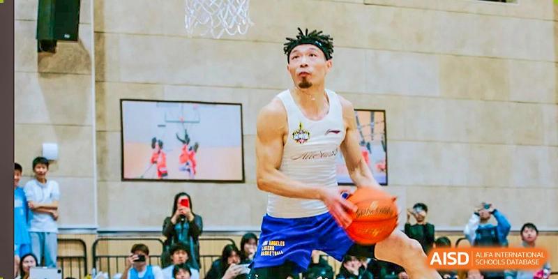 A basketball player from Suzhou North America High School is dribbling the ball during a game.