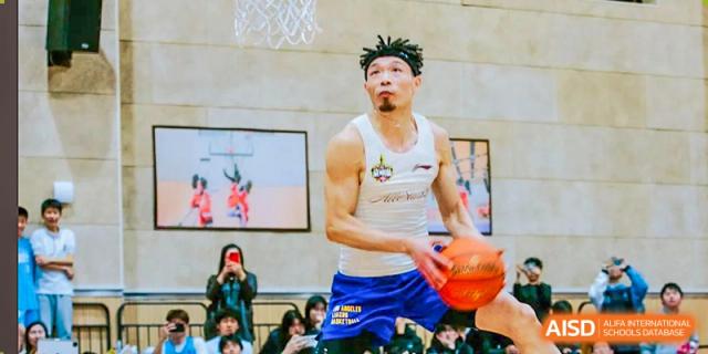 A basketball player from Suzhou North America High School is dribbling the ball during a game.