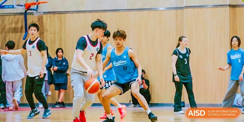 Two basketball players from Suzhou North America High School are competing for the ball during a game.