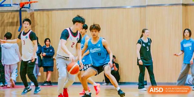 Two basketball players from Suzhou North America High School are competing for the ball during a game.