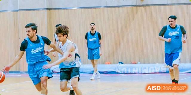 Basketball players from Suzhou North America High School are on the court during a game.