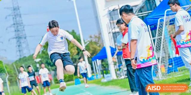Students from Suzhou North America High School are participating in an outdoor sports game.