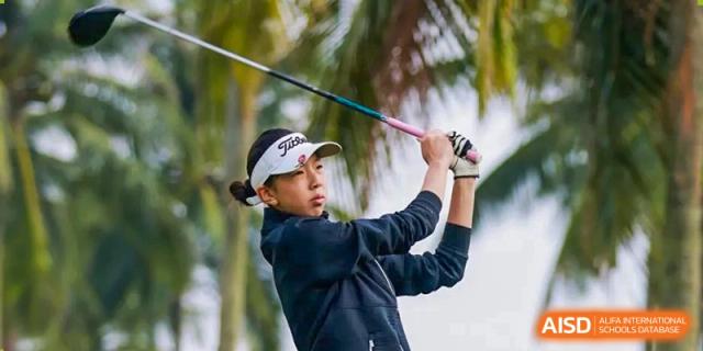 A student from Suzhou North America High School is playing golf and swinging a club.