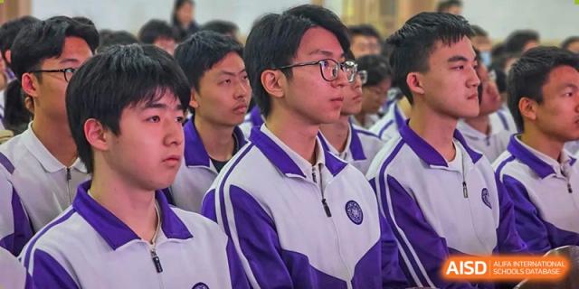 Male students from Tianjin Nankai High School  are in a group, with one student in the foreground looking forward attentively.