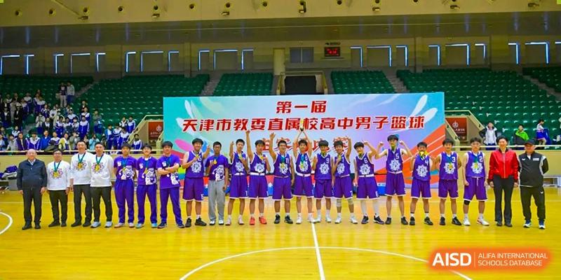 A team photo of the Tianjin Nankai High School  boys' basketball team standing on the court, celebrating a win.
