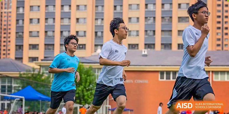 A male student from Wellington College International Tianjin runs on a track during a sports activity.