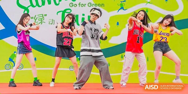 Two students from Wellington College International Tianjin are performing a dance routine on a stage.