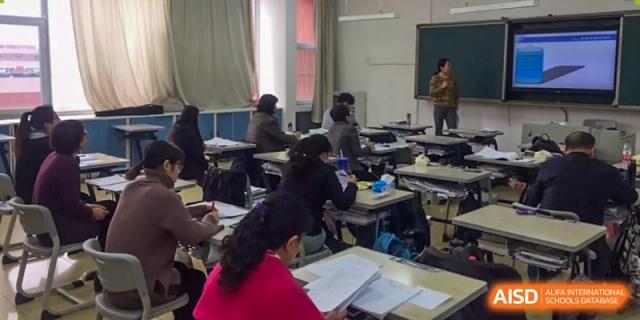 Students seated at desks in a classroom during a lesson at Yang Guang Qing International School of Beijing.