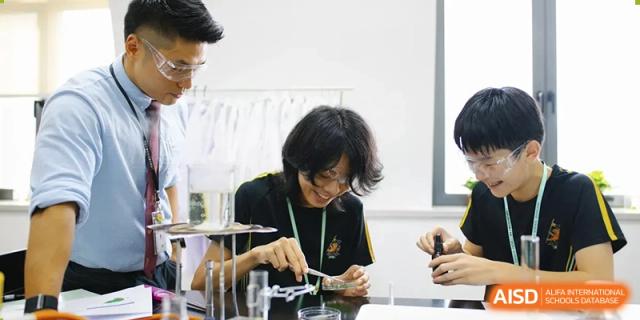 A Huili School Shanghai student performing a precise task with equipment in a laboratory setting.