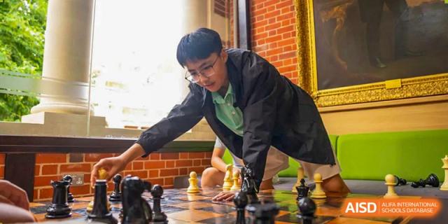 A Huili School Shanghai student concentrates while making a move during a competitive chess match.