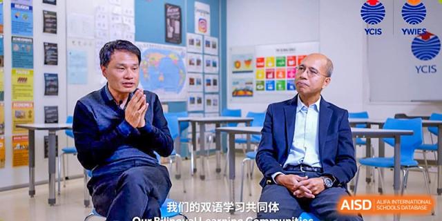 A teacher and student sitting and talking in a modern classroom at Yew Wah International Education School of Shanghai Gubei.