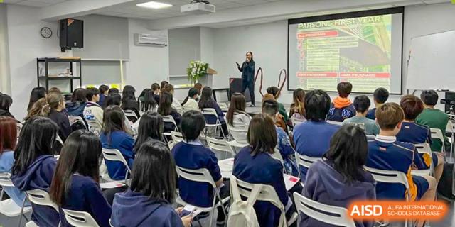 A classroom scene with students listening to a teacher giving a presentation at Yew Wah International Education School of Shanghai Gubei.