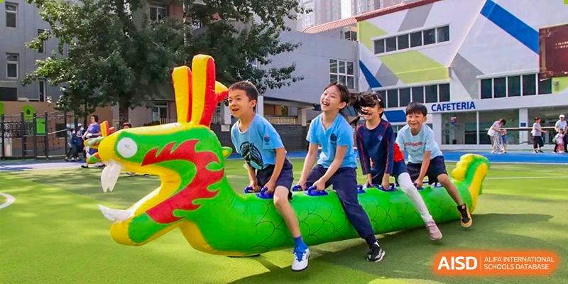 Students playing on colorful outdoor playground equipment at Yew Wah International Education School of Shanghai Gubei.