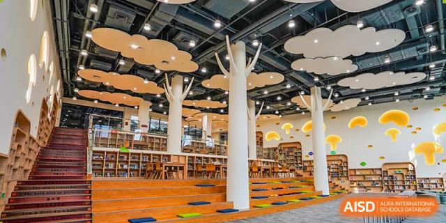 A modern library at Shenzhen Foreign Languages GBA Academy with tree-shaped columns and comfortable seating.
