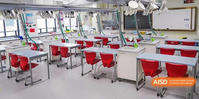 An empty science lab with red chairs and lab tables at Shenzhen Foreign Languages GBA Academy.